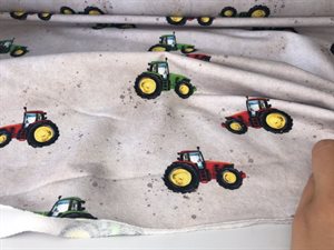 Let isoli - røde og grønne traktorer på flot plettet bund